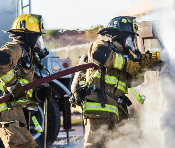 Firefighters hosing down a fire.